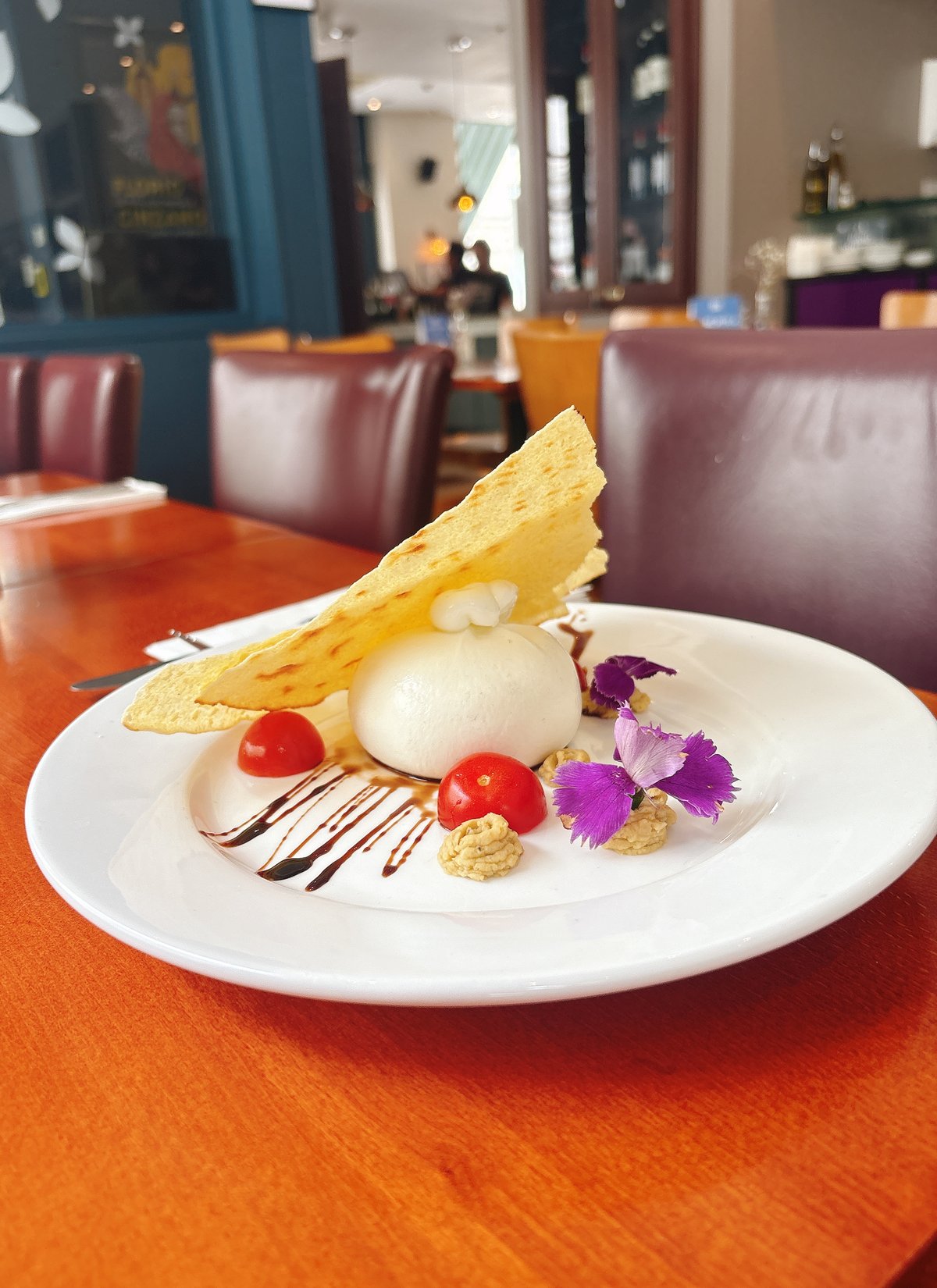 Buratta served with cherry tomatoes, avocado purée, balsamic reduction, Carasau crisp bread.