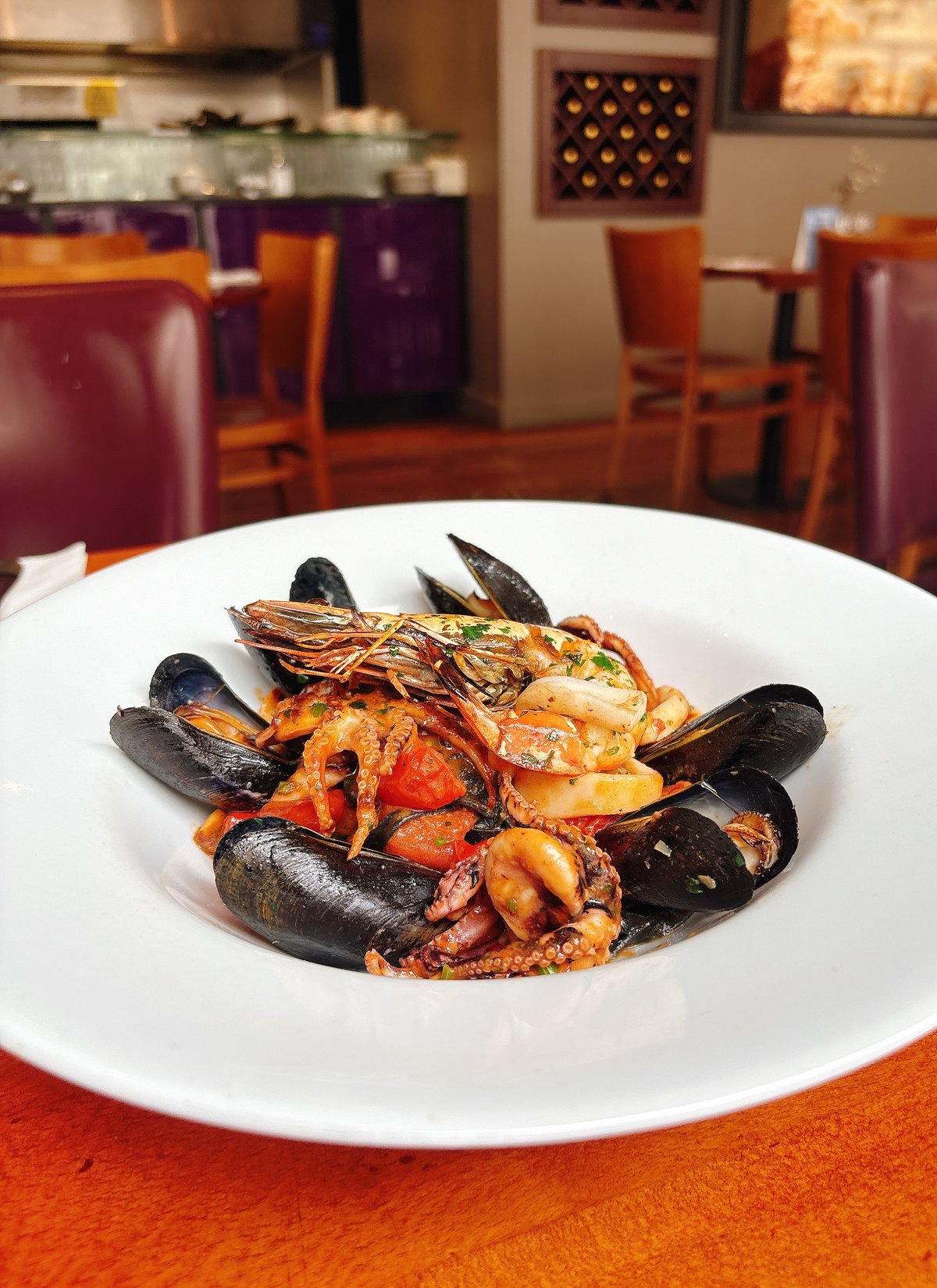 Linguine di Mare: Fresh squid ink black pasta, clams, mussels, octopus, calamari, tomato, chilli, parsley, wine and king prawn.