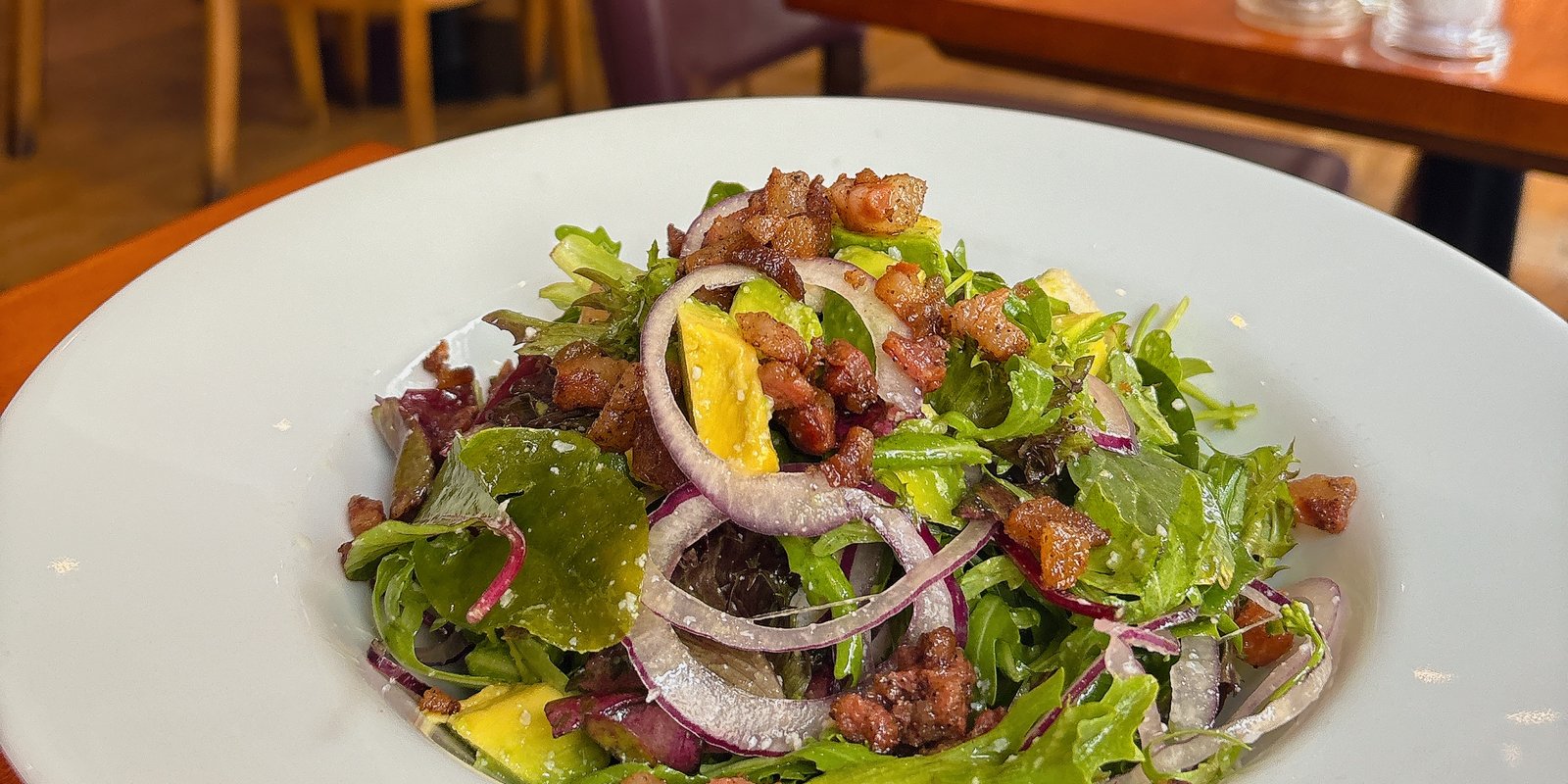 Insalate Locale: Chopped avocado, gorgonzola, pancetta, red onion, mixed leaves.